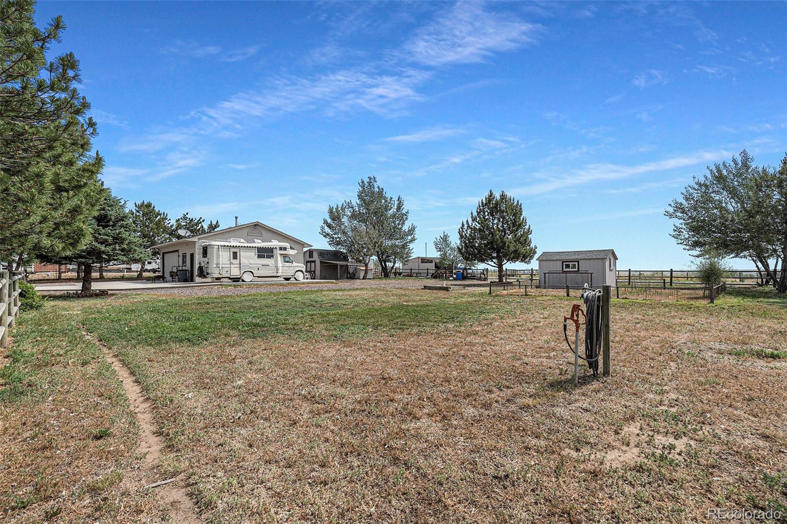 15482 Gadsden Drive Brighton, CO 80603 - Photo 31 of 43 a view of green field with tree in the background