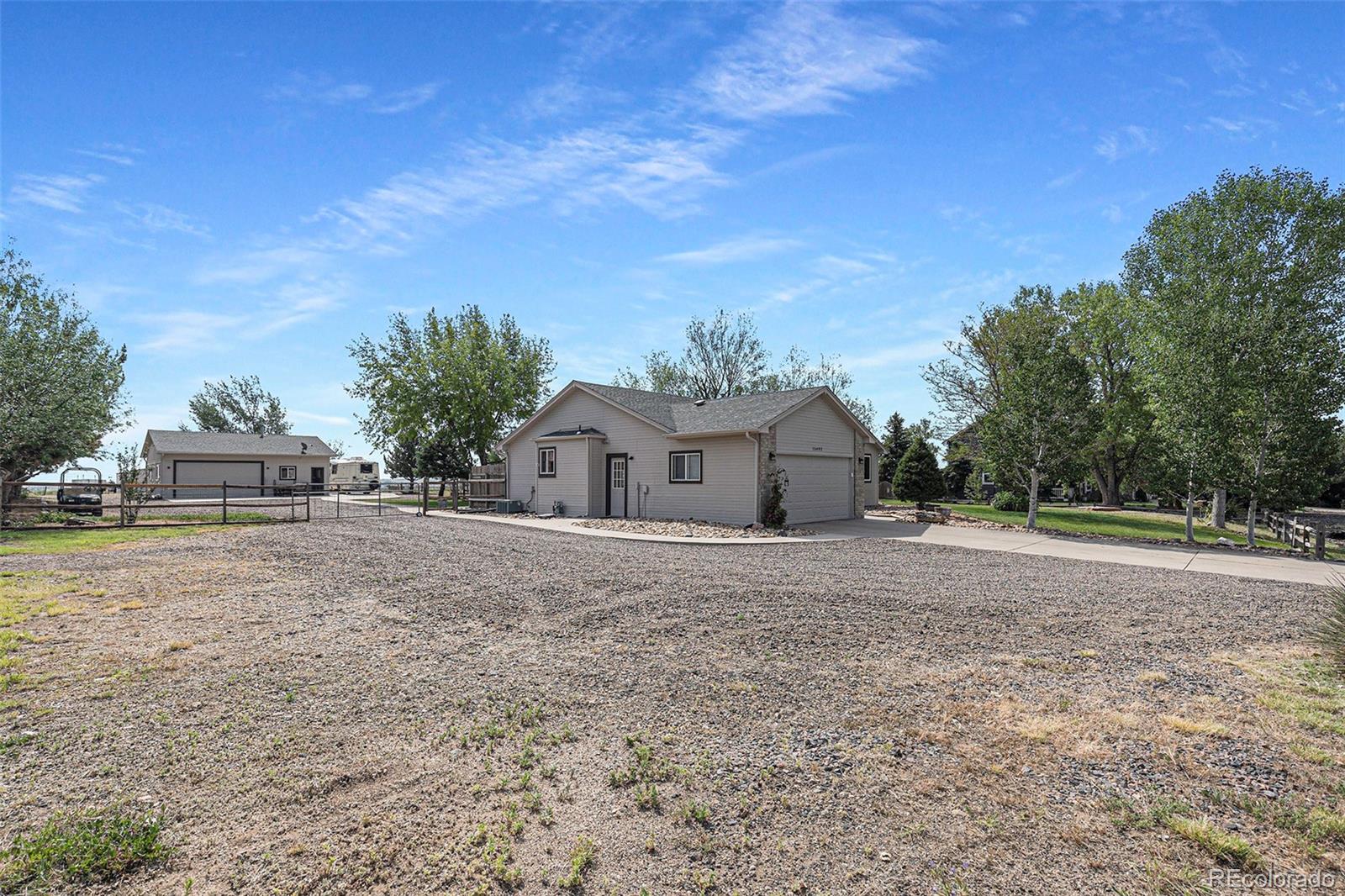 15482 Gadsden Drive Brighton, CO 80603 - Photo 5 of 43 a front view of a house with a yard and trees
