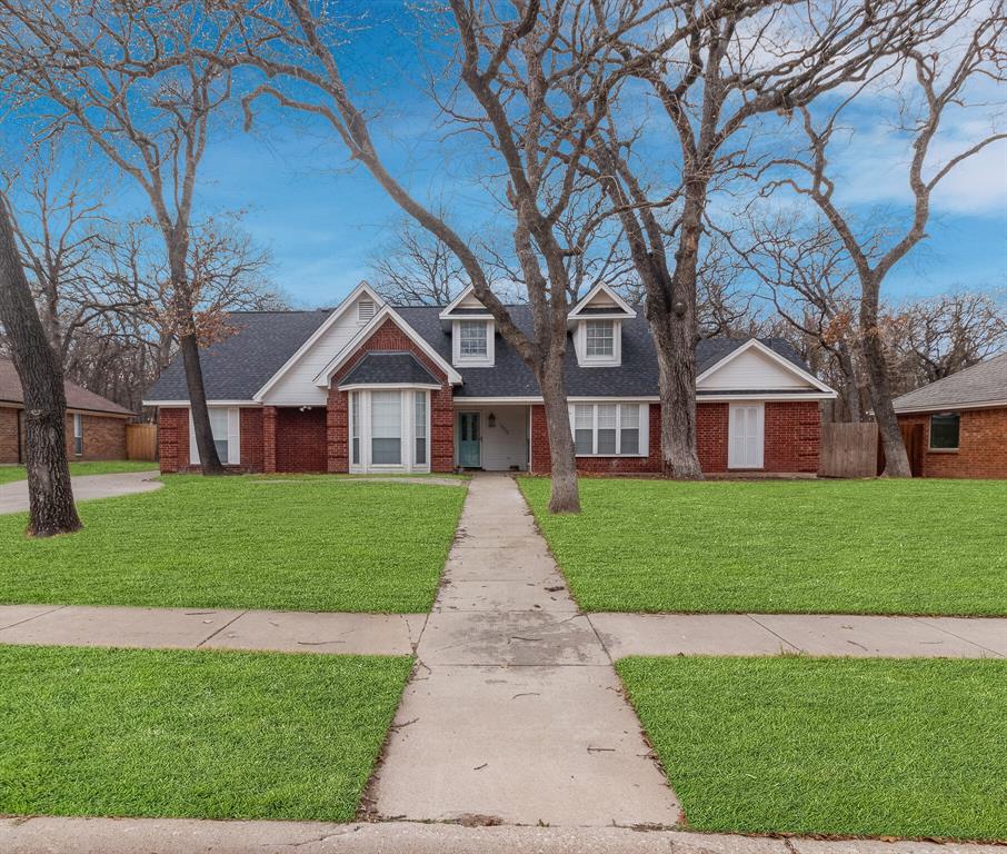 1509 Spinnaker Lane Azle, TX 76020 - Photo 1 of 1 a view of a brick house in front of yard and couple of flower plants