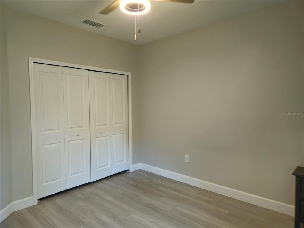 3633 Main Street Sanford, FL 32771 - Photo 12 of 17 an empty room with wooden floor closet and windows