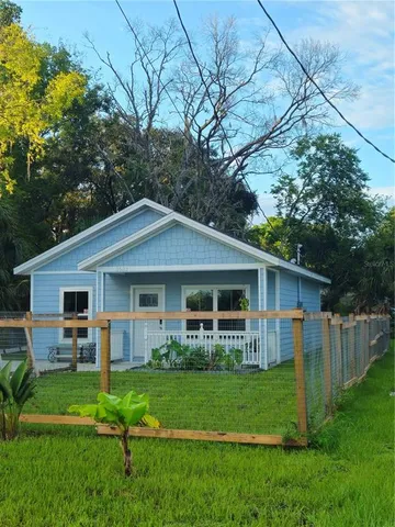 a front view of house with a garden and patio