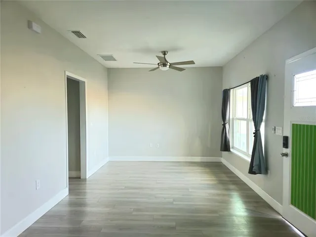 wooden floor in an empty room with a window