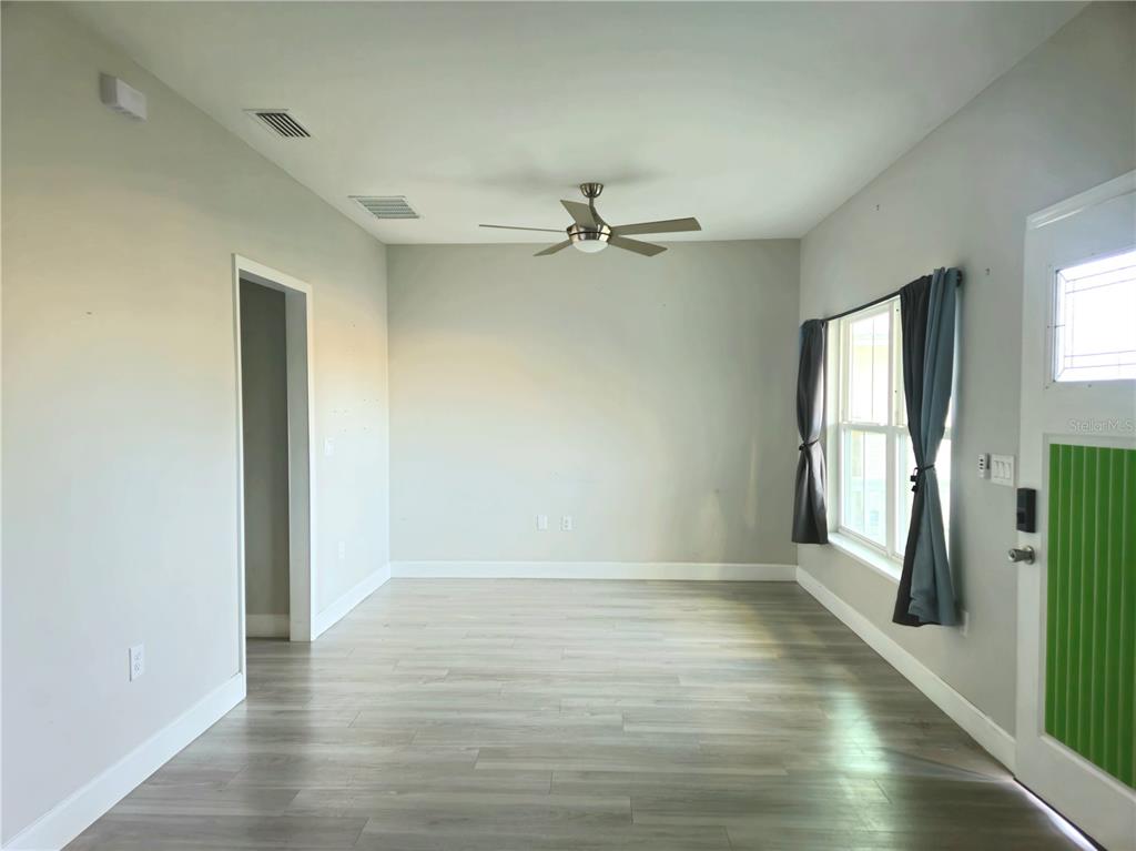 3633 Main Street Sanford, FL 32771 - Photo 3 of 17 wooden floor in an empty room with a window