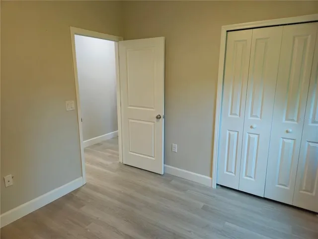 an empty room with wooden floor