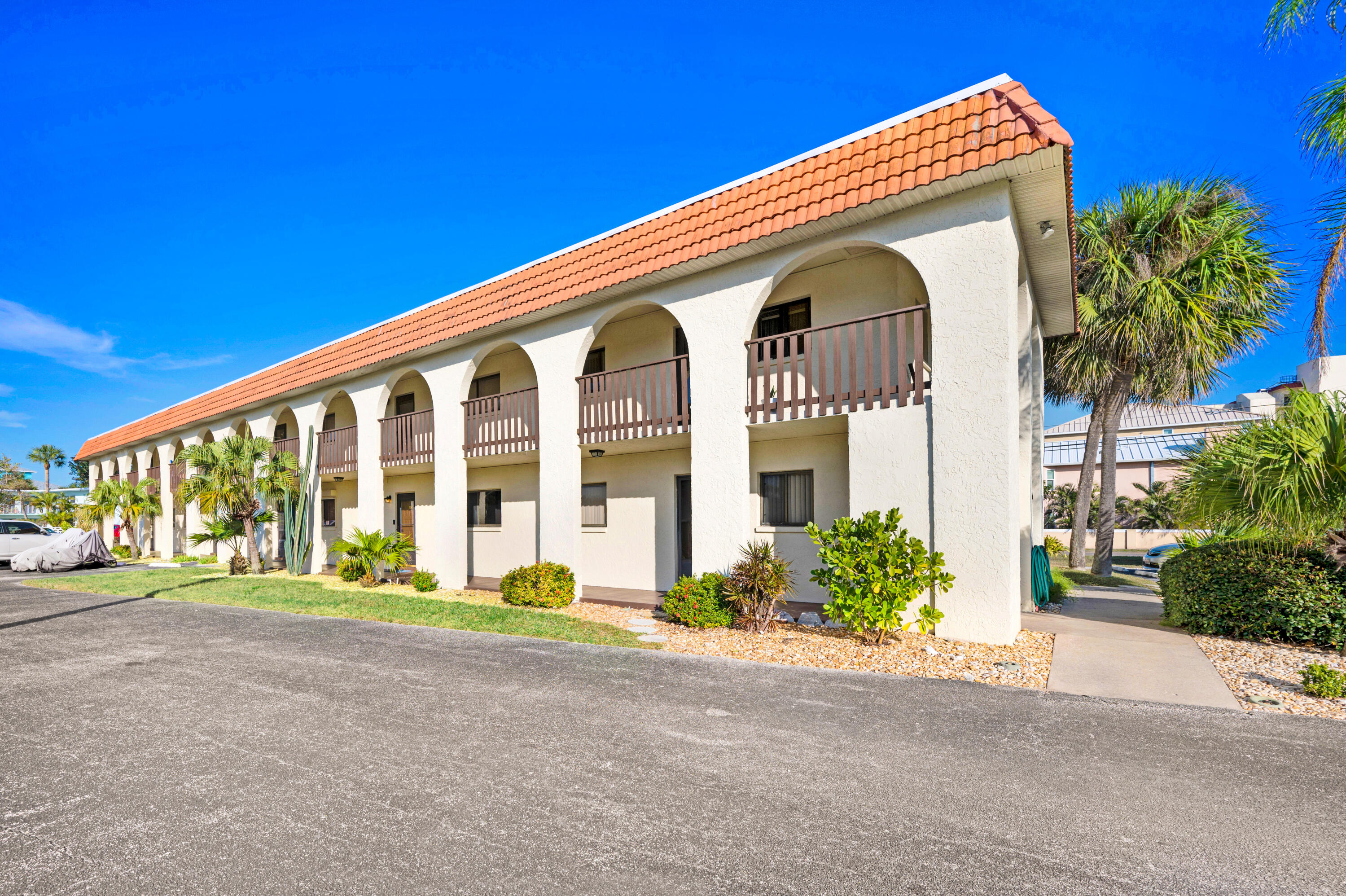 6655 Ridgewood Avenue, Unit 104 Cocoa Beach, FL 32931 - Photo 1 of 25 a front view of house with a garden