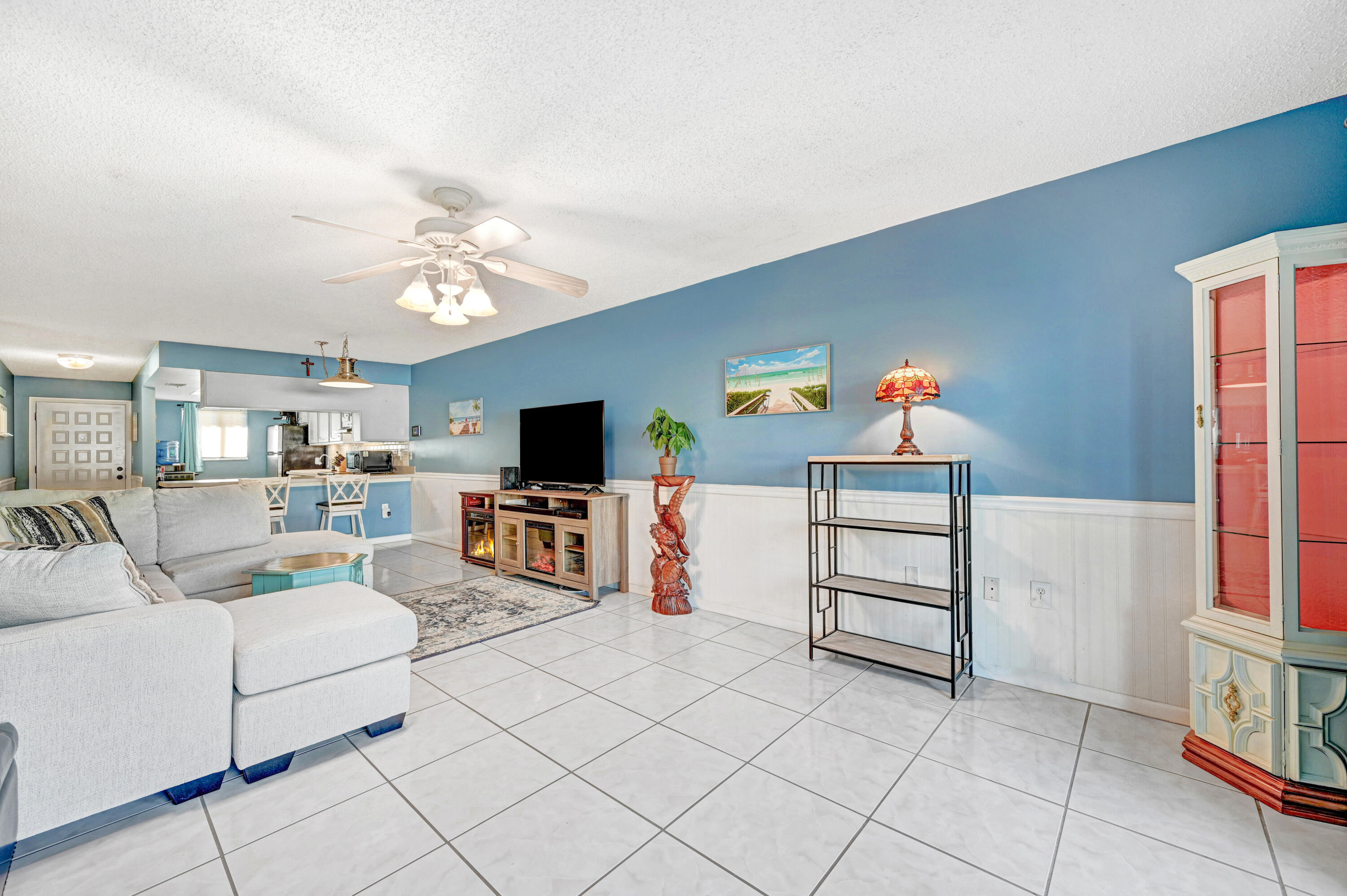 6655 Ridgewood Avenue, Unit 104 Cocoa Beach, FL 32931 - Photo 11 of 25 a living room with furniture and a flat screen tv
