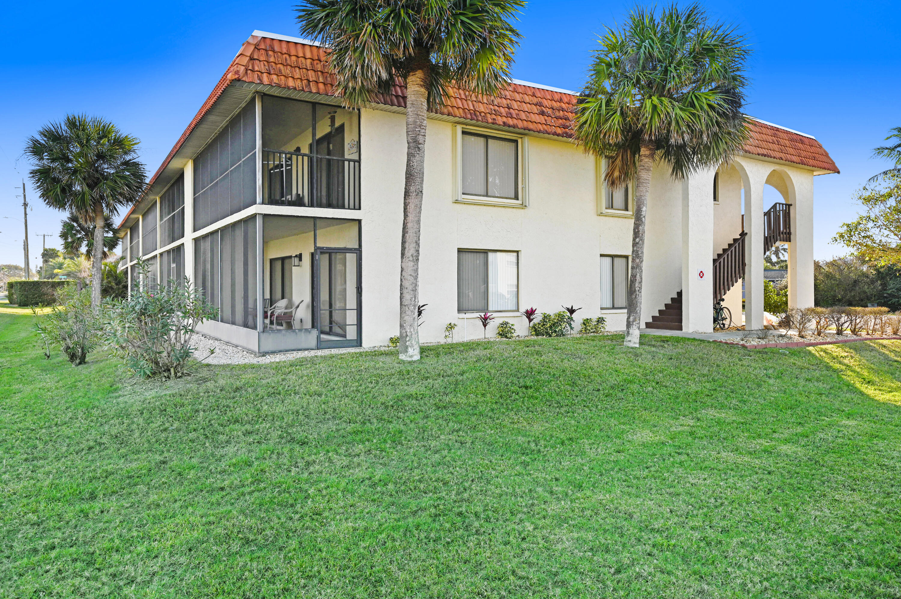 6655 Ridgewood Avenue, Unit 104 Cocoa Beach, FL 32931 - Photo 23 of 25 a front view of house with yard and green space