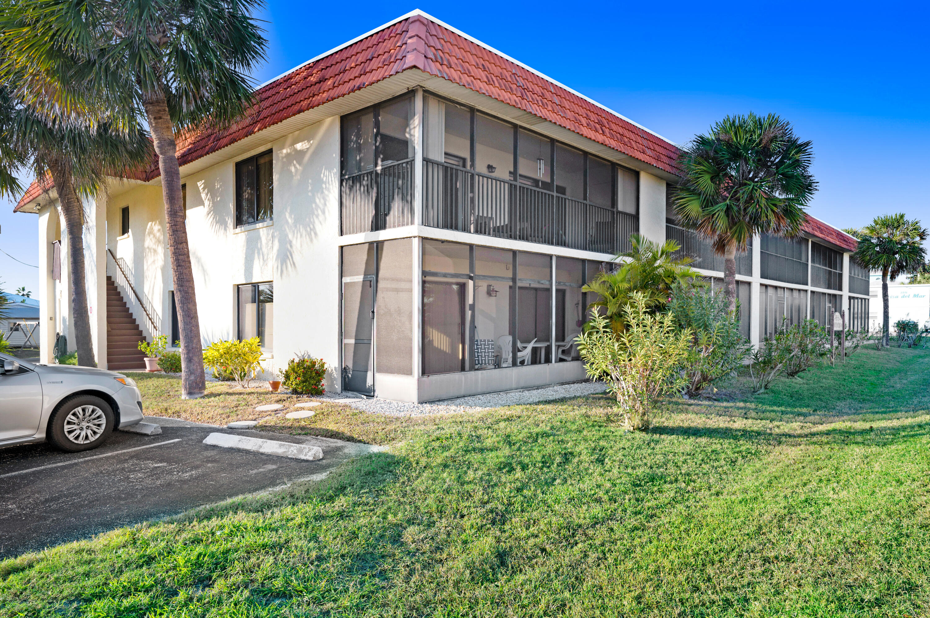6655 Ridgewood Avenue, Unit 104 Cocoa Beach, FL 32931 - Photo 25 of 25 a front view of a house with garden