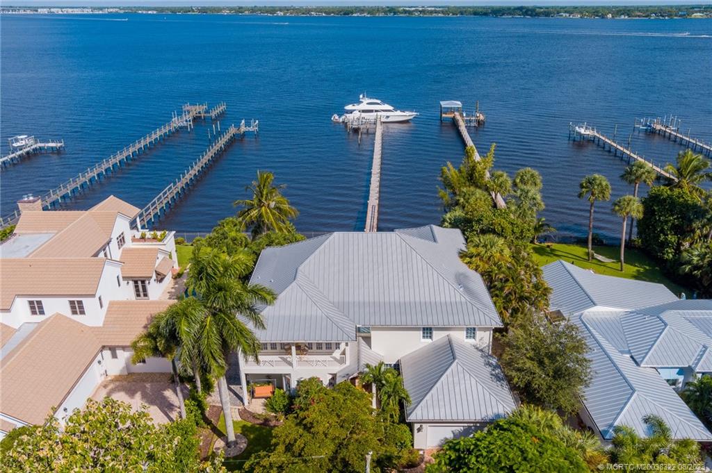 1455 Southeast Riverside Drive Stuart, FL 34996 - Photo 35 of 100 an aerial view of a house with balcony and outdoor space