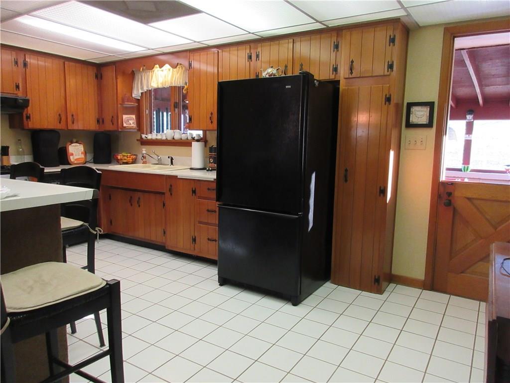 174 Elliott Road Sarver, PA 16055 - Photo 9 of 25 Plenty of cabinet space, double bowl sink with a view of the sunroom off the back.