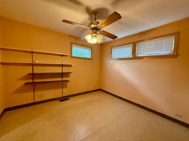 a view of a room with a ceiling fan