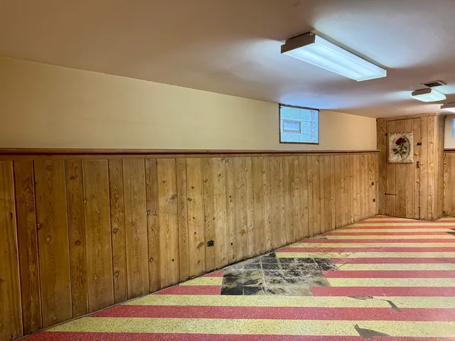 a view of a livingroom with wooden floor and a ceiling fan