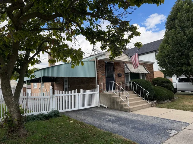a house that has a tree in front of it