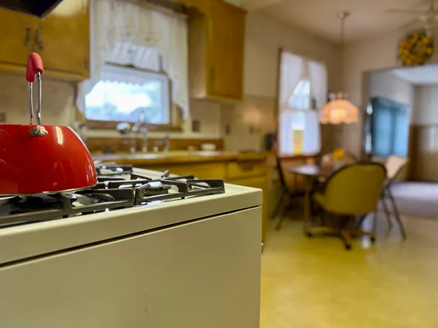 a stove top oven sitting inside of a kitchen