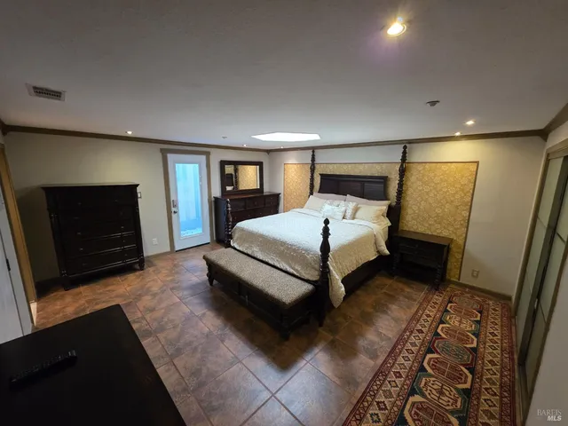 a bedroom with a bed and a couch