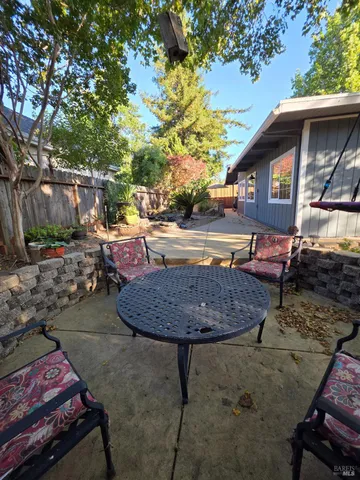 a swimming pool with outdoor seating and yard