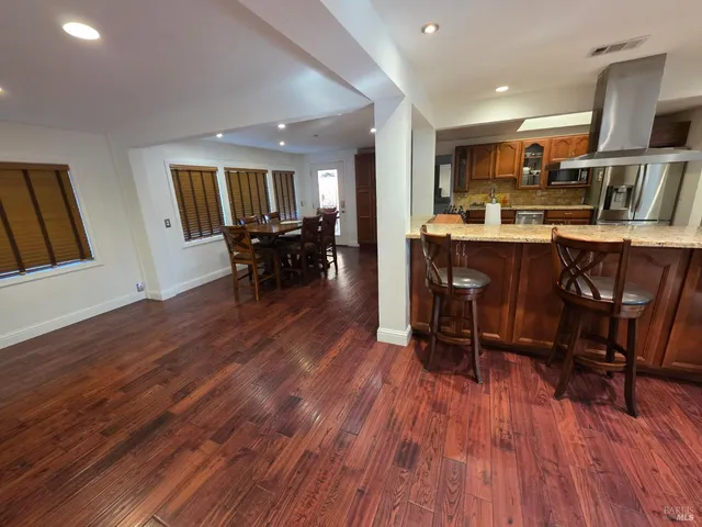a view of kitchen with cabinets and wooden floor
