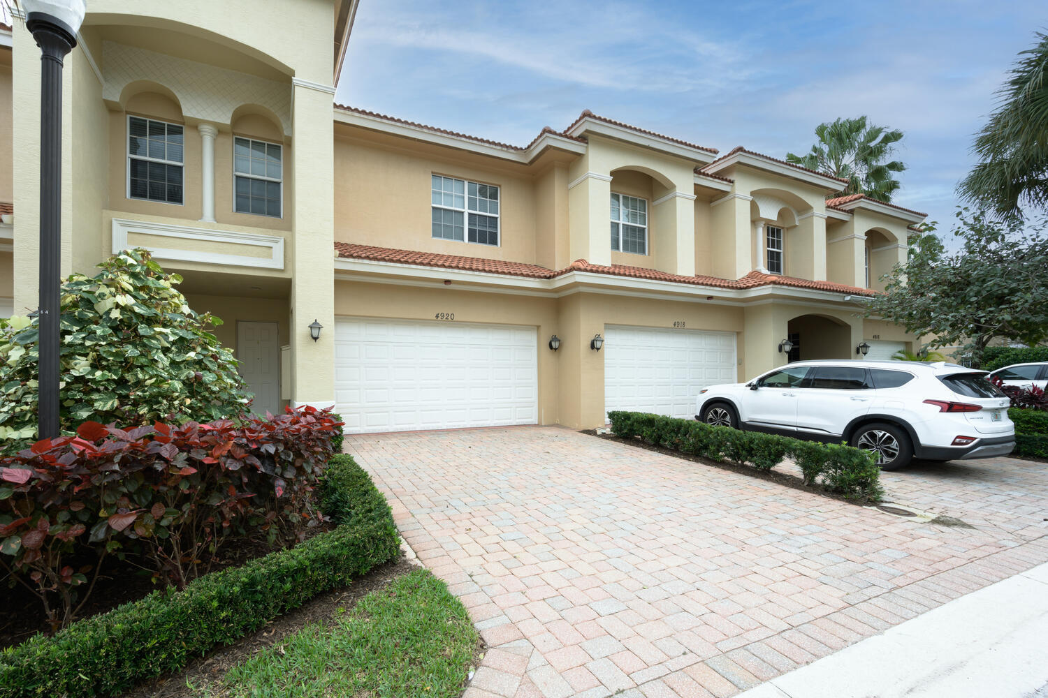 4920 Vine Cliff Way East Palm Beach Gardens, FL 33418 - Photo 1 of 25 a front view of a house with a garden