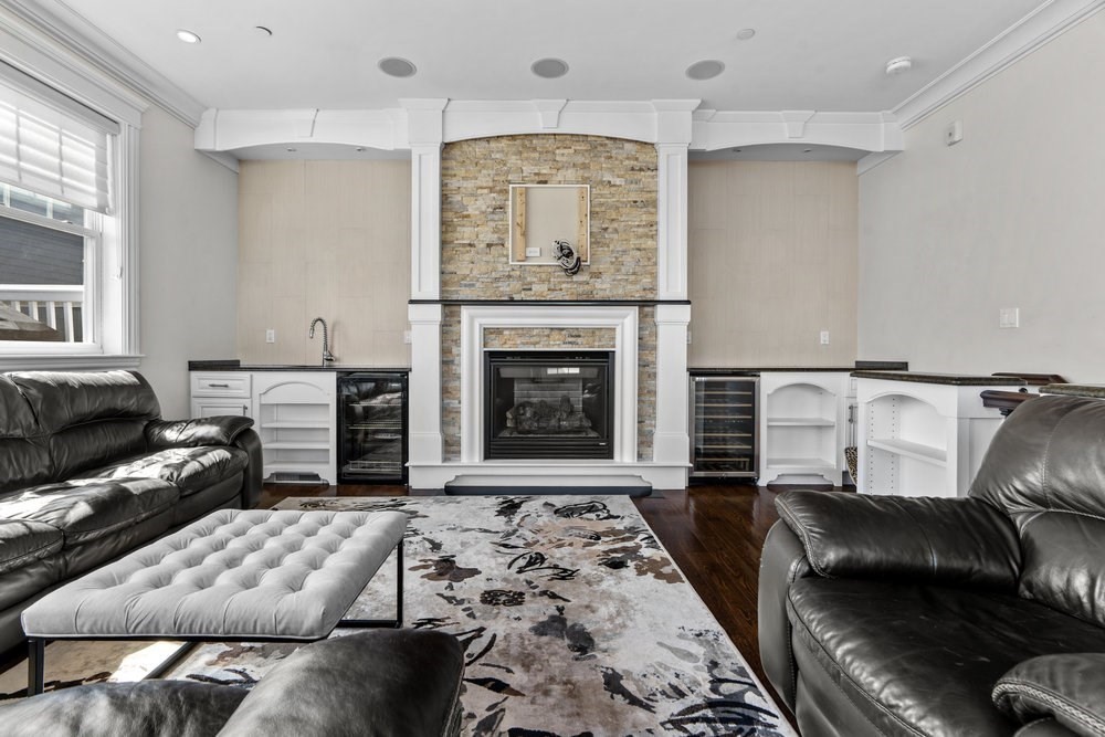 161 Tudor Street, Unit 4A Boston, MA 02127 - Photo 26 of 32 a living room with furniture and a fireplace