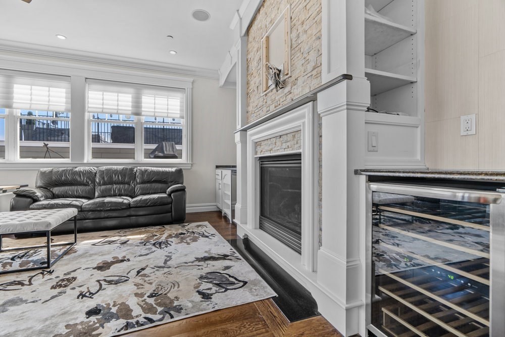 161 Tudor Street, Unit 4A Boston, MA 02127 - Photo 29 of 32 a living room with furniture or couch and a fireplace