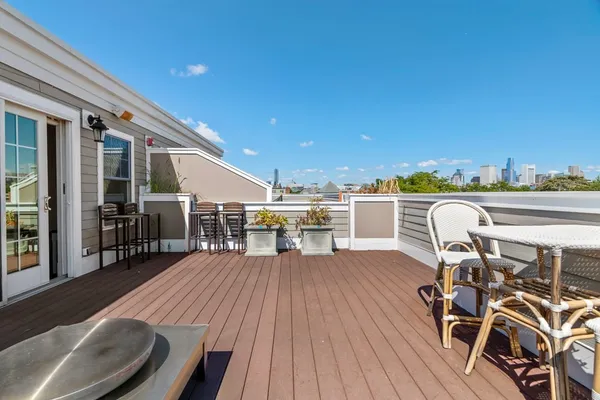 a balcony with table and chairs