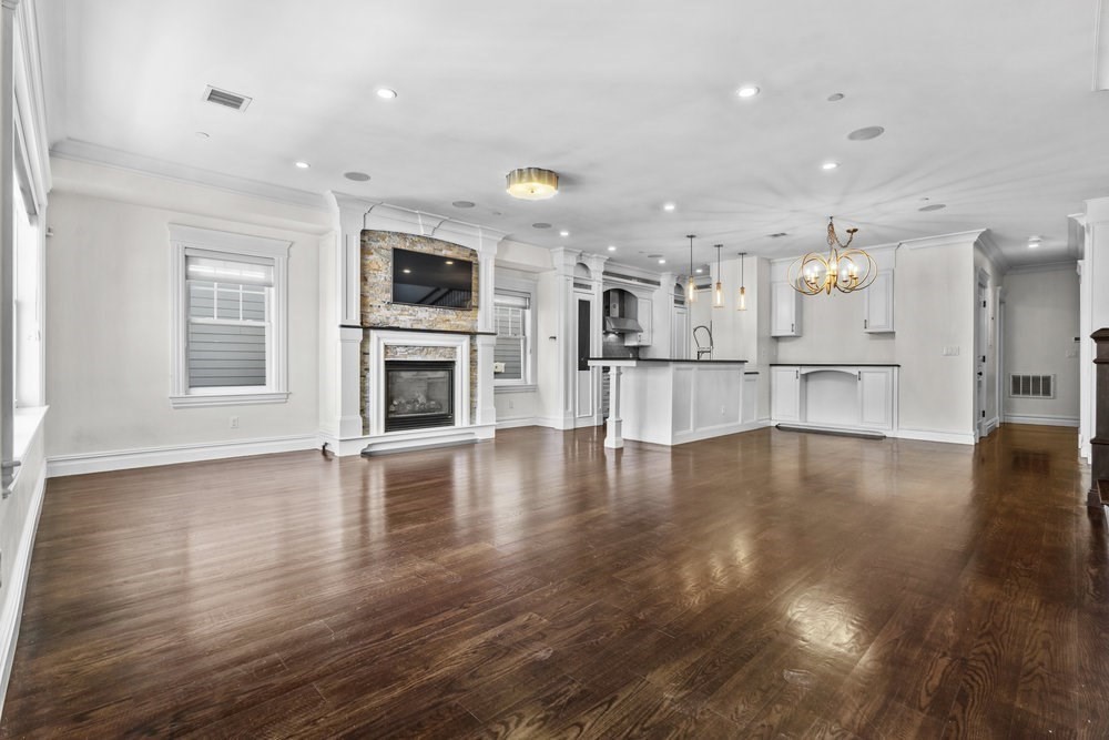161 Tudor Street, Unit 4A Boston, MA 02127 - Photo 6 of 32 a view of a kitchen with a flat screen tv and wooden floor
