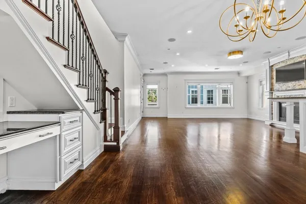 a view of an entryway with wooden floor
