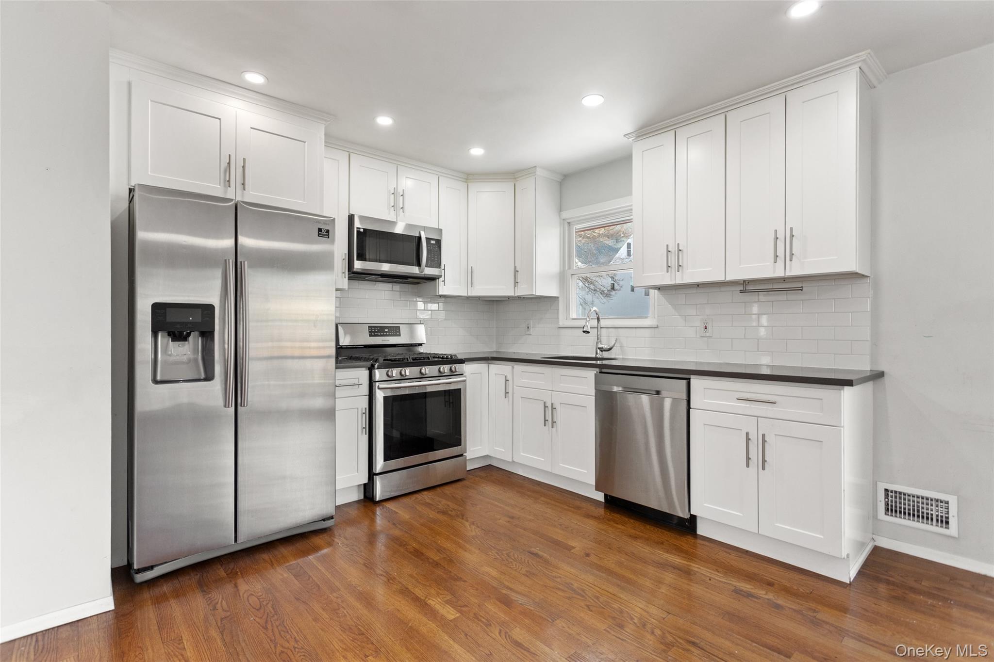 11 Muir Place New Rochelle, NY 10801 - Photo 7 of 30 Renovated Kitchen with Stainless Steel Appliances