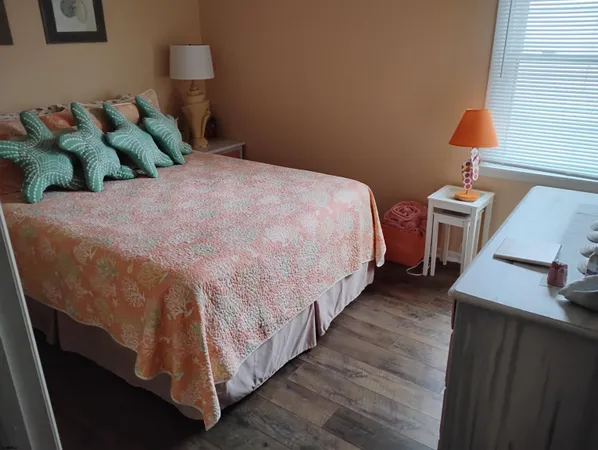 a bed sitting in a bedroom next to a lamp