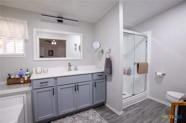 a spacious bathroom with a double vanity sink mirror and shower