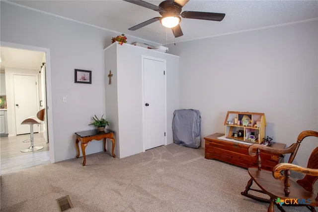 a view of a workspace with furniture and a window