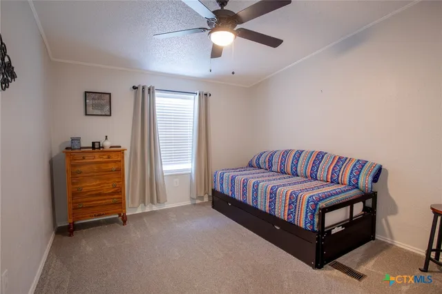 a living room with furniture and a ceiling fan