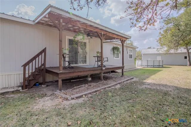 a view of a house with backyard and porch