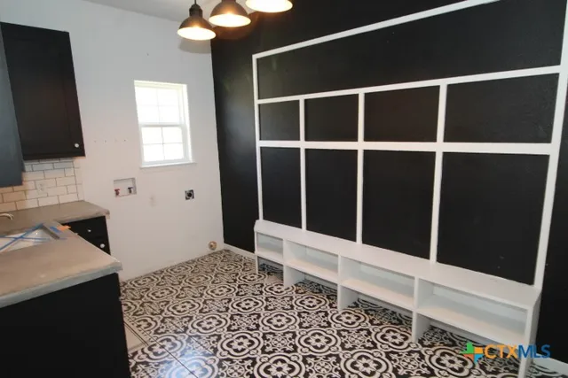 a room with a flat screen tv and a rug