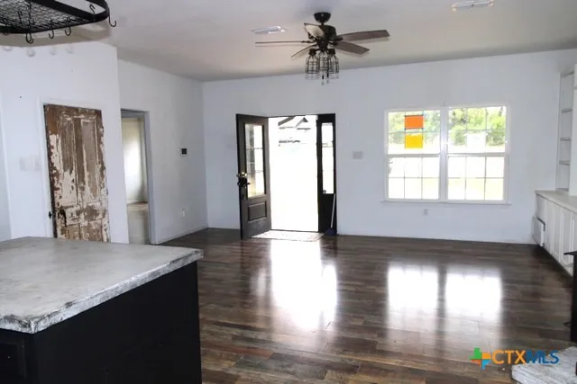 a view of entryway and hall with wooden floor
