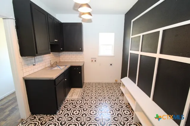 a bathroom with a sink vanity and a mirror