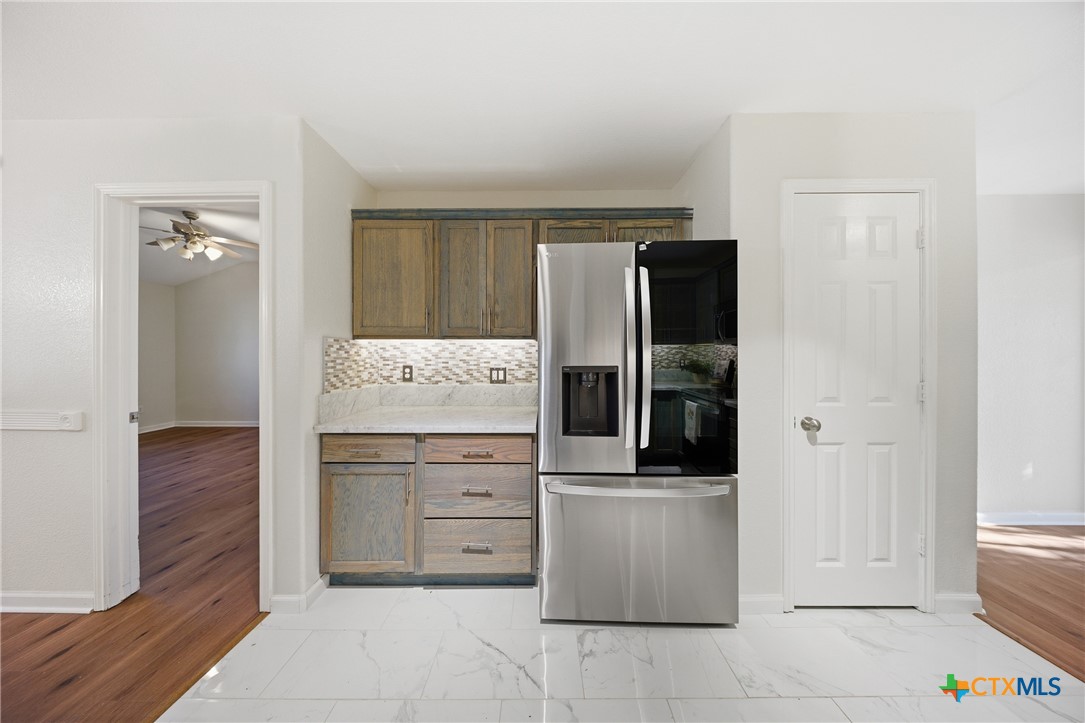 658 Devin Drive Temple, TX 76502 - Photo 14 of 30 a kitchen with a refrigerator and cabinets