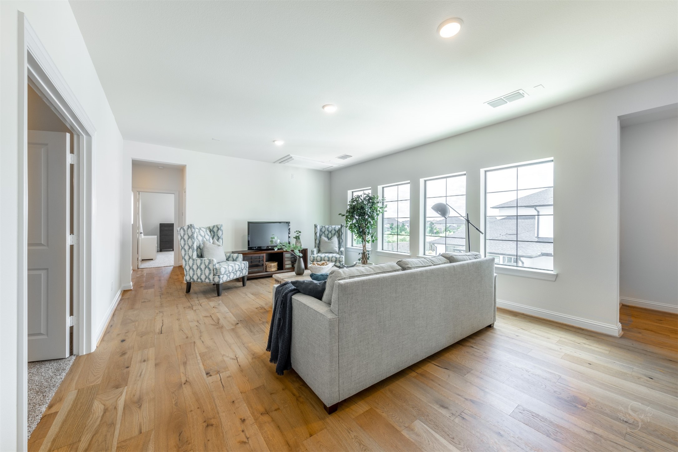 27919 Indigo Ridge Drive Fulshear, TX 77441 - Photo 34 of 50 a living room with furniture and a wooden floor