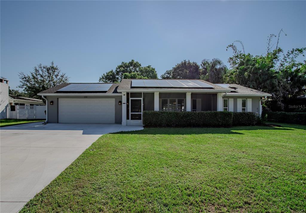 a front view of a house with a garden and yard