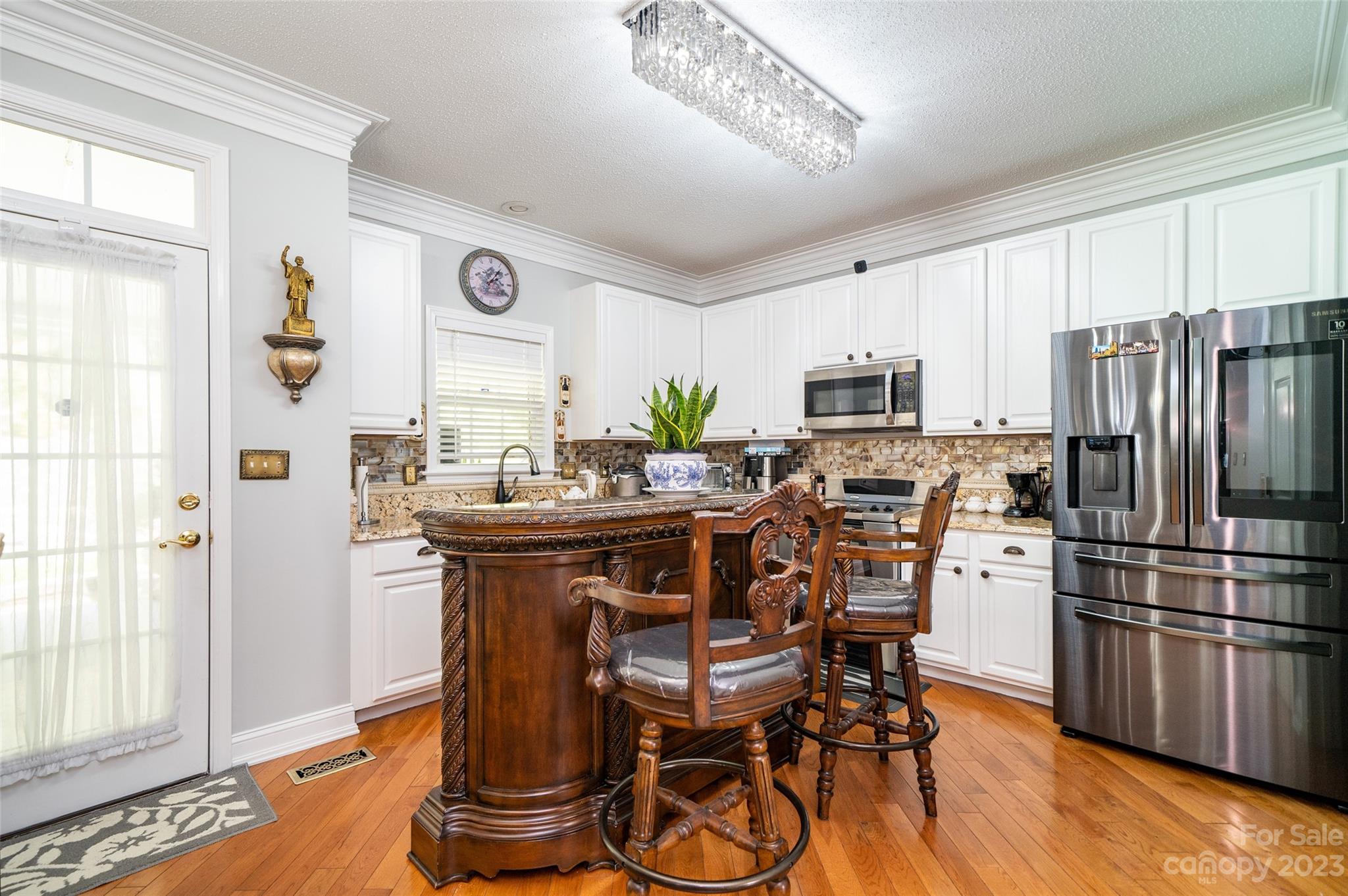 67 Walnut Crest Road Fletcher, NC 28732 - Photo 13 of 36 a kitchen with stainless steel appliances granite countertop a refrigerator a stove a sink dishwasher and white cabinets with wooden floor