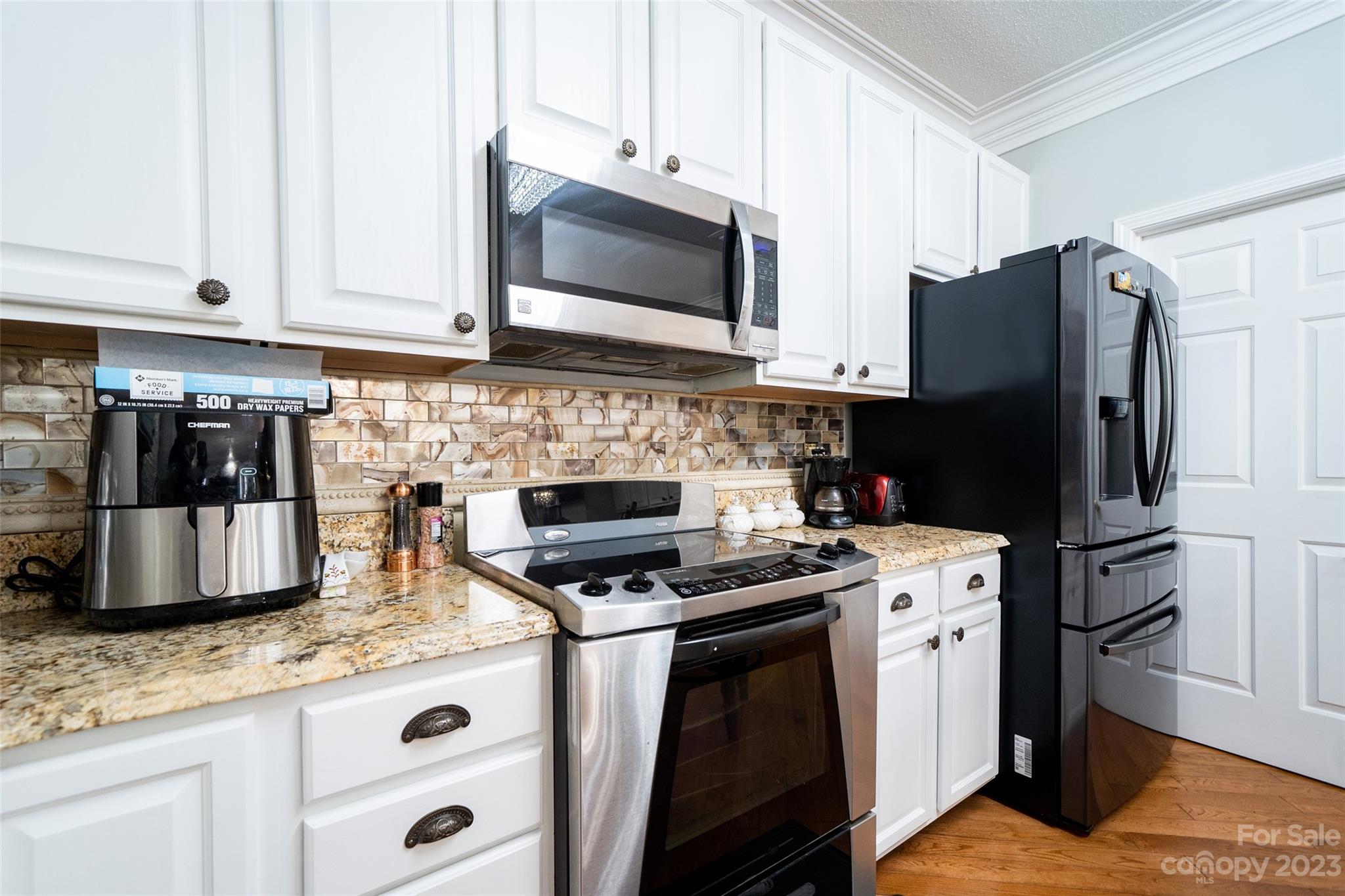 67 Walnut Crest Road Fletcher, NC 28732 - Photo 14 of 36 a kitchen with granite countertop a refrigerator stove and microwave