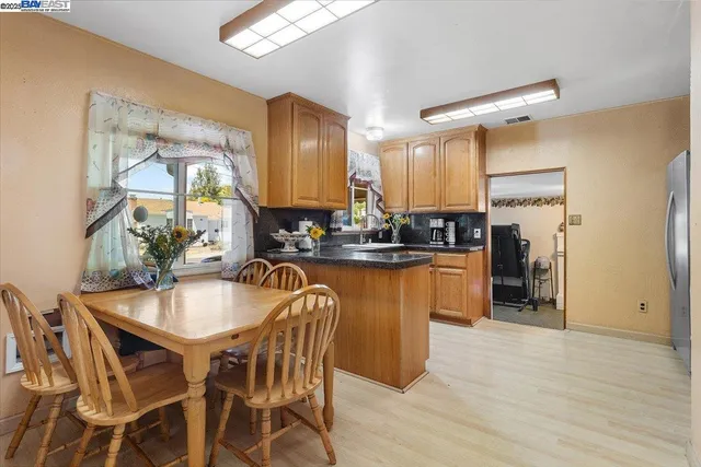a kitchen with a table chairs sink and cabinets