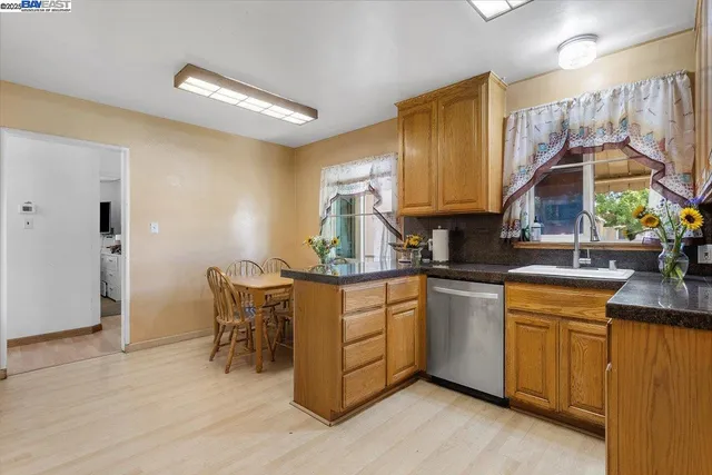 a kitchen with a sink cabinets and wooden floor