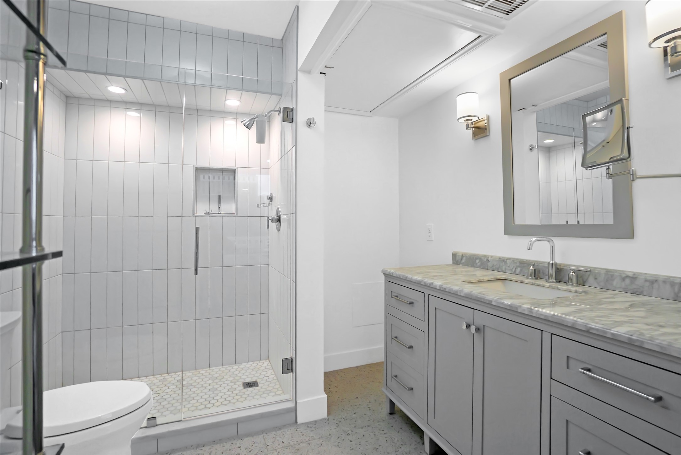 1212 Guadalupe Street, Unit 1004 Austin, TX 78701 - Photo 25 of 33 a bathroom with a granite countertop sink toilet and shower