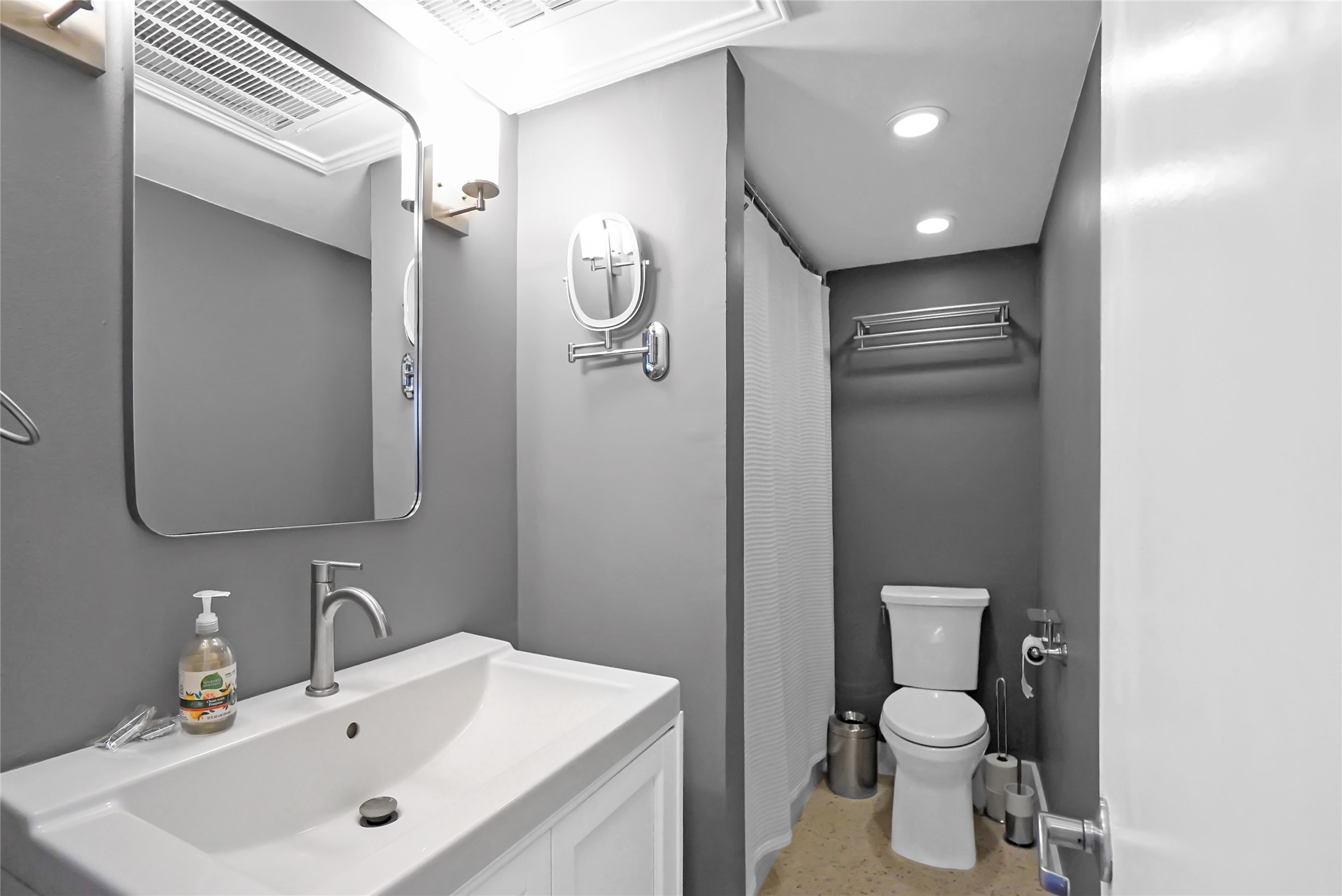 1212 Guadalupe Street, Unit 1004 Austin, TX 78701 - Photo 31 of 33 a bathroom with a toilet sink shower and mirror