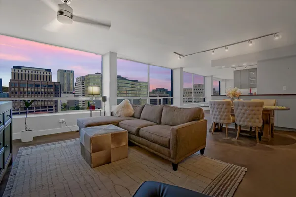 a living room with furniture and a floor to ceiling window
