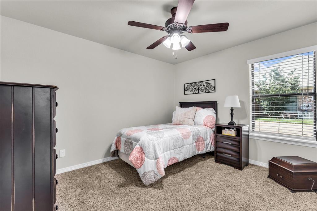 814 Springdale Circle Lorena, TX 76655 - Photo 16 of 37 Well-lit interior room featuring light-colored walls, brown carpet flooring, and a window with horizontal blinds