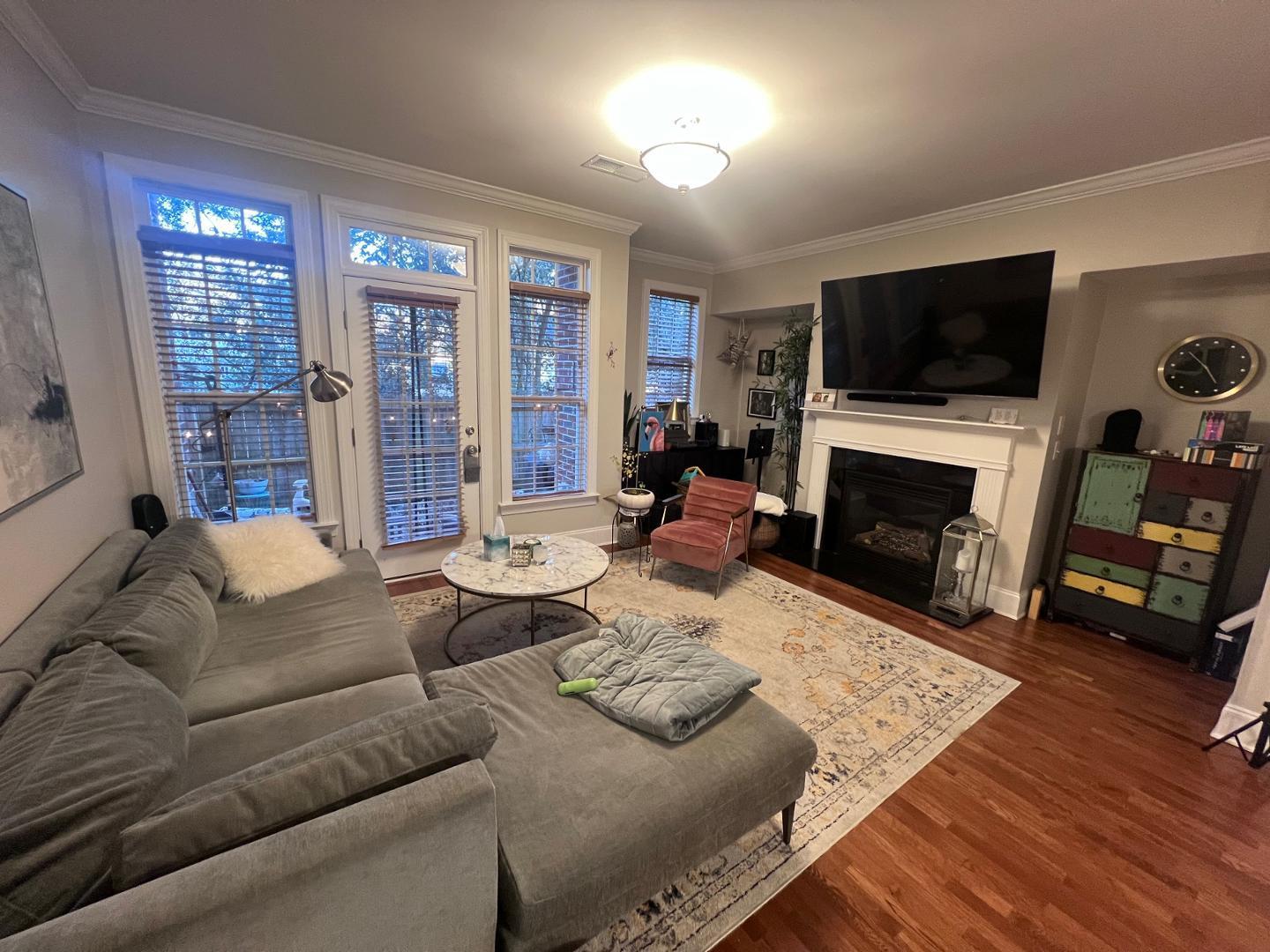 655 Highpark Lane Raleigh, NC 27608 - Photo 2 of 12 a living room with furniture a flat screen tv and a fireplace