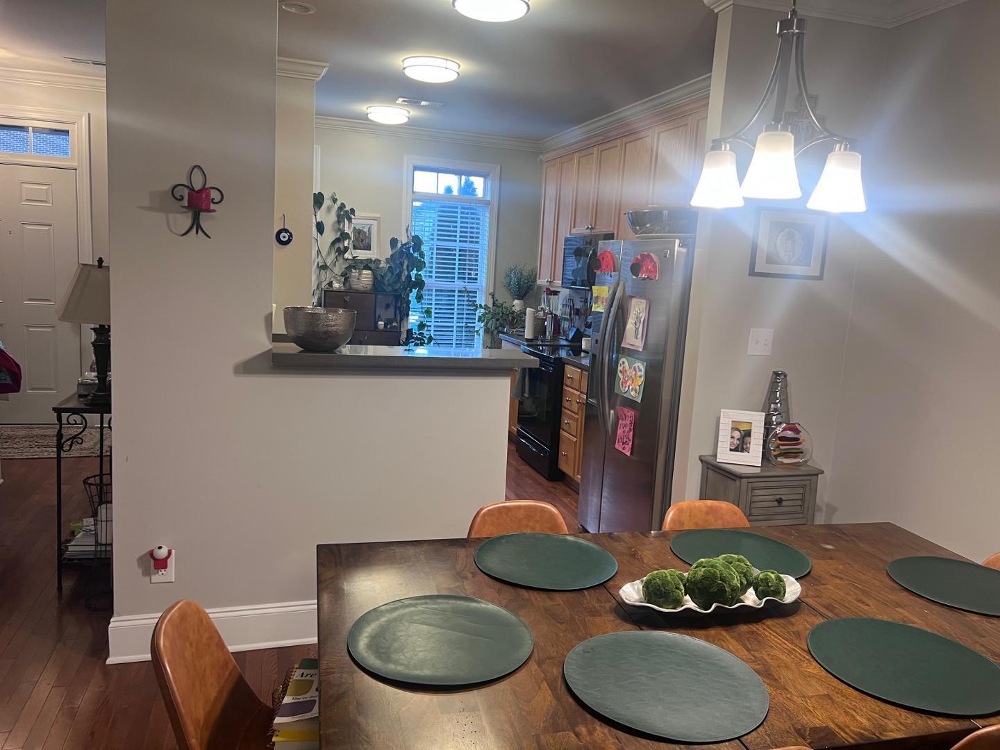 655 Highpark Lane Raleigh, NC 27608 - Photo 5 of 12 a kitchen with stainless steel appliances granite countertop a sink and a wooden floor