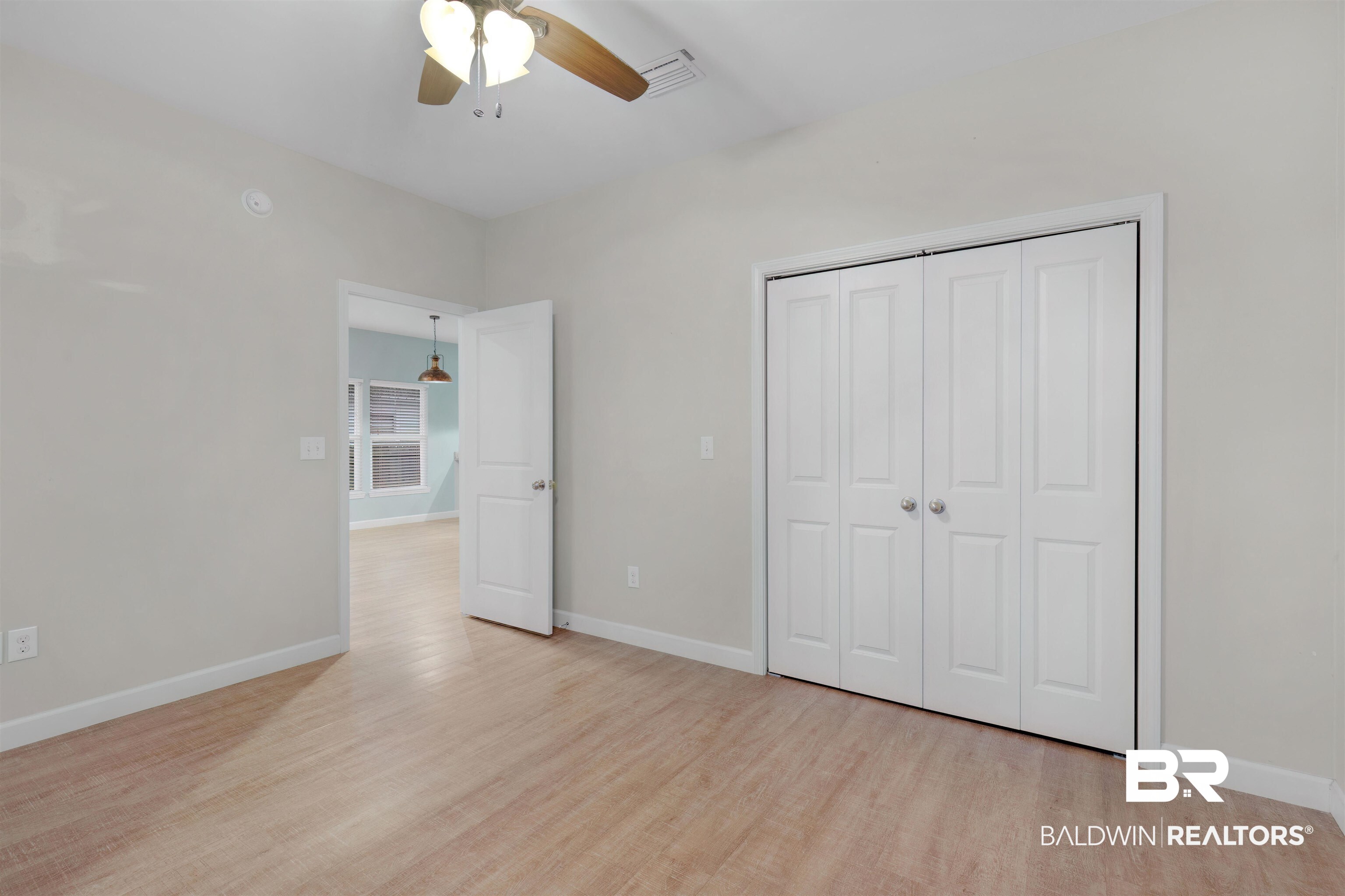 5625 Georgia Street Orange Beach, AL 36561 - Photo 20 of 30 Unfurnished bedroom featuring ceiling fan, light hardwood / wood-style flooring, and a closet